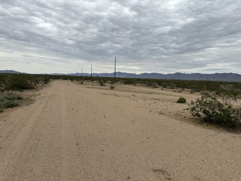 Dirt road with power lines near RV Safe Site in Golden Valley, AZ, a stop for fall RV travel Mohave County